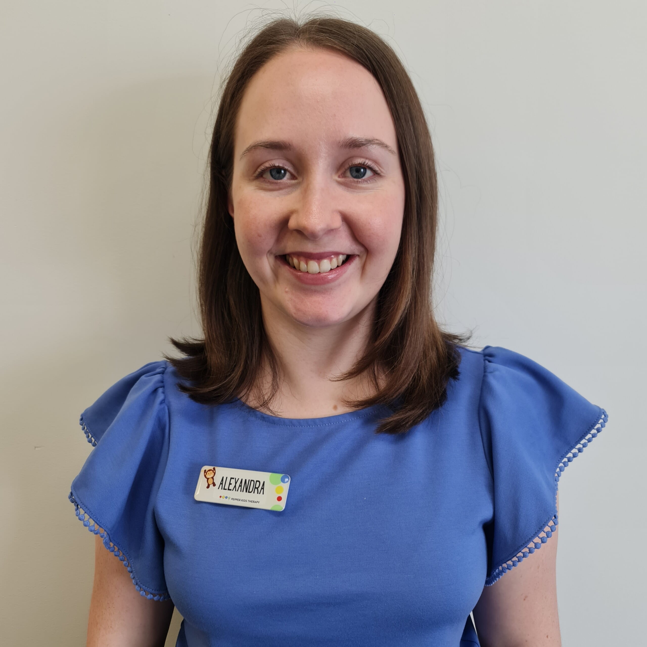 Alexandra Jones, a smiling woman in a blue shirt.