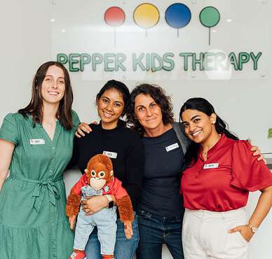 Pepper Kids Therapy workers with mascot, George