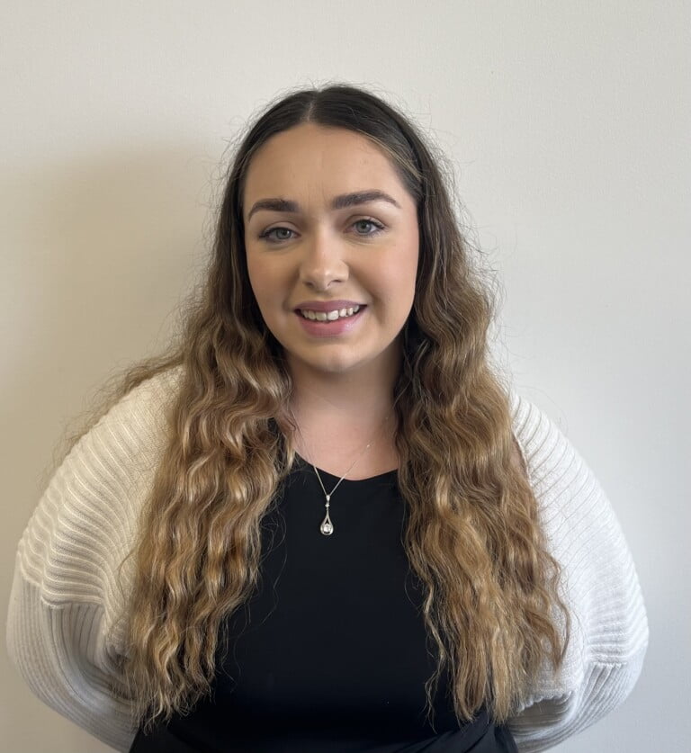 Brearnna Glover, a young woman wearing a white shirt and necklace.